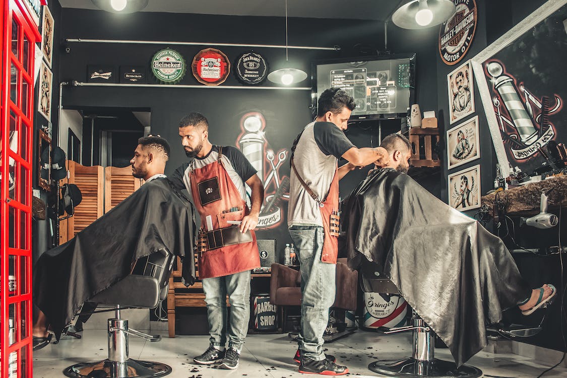 men having haircut in barber shop