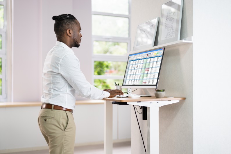 Man working at small standing desk